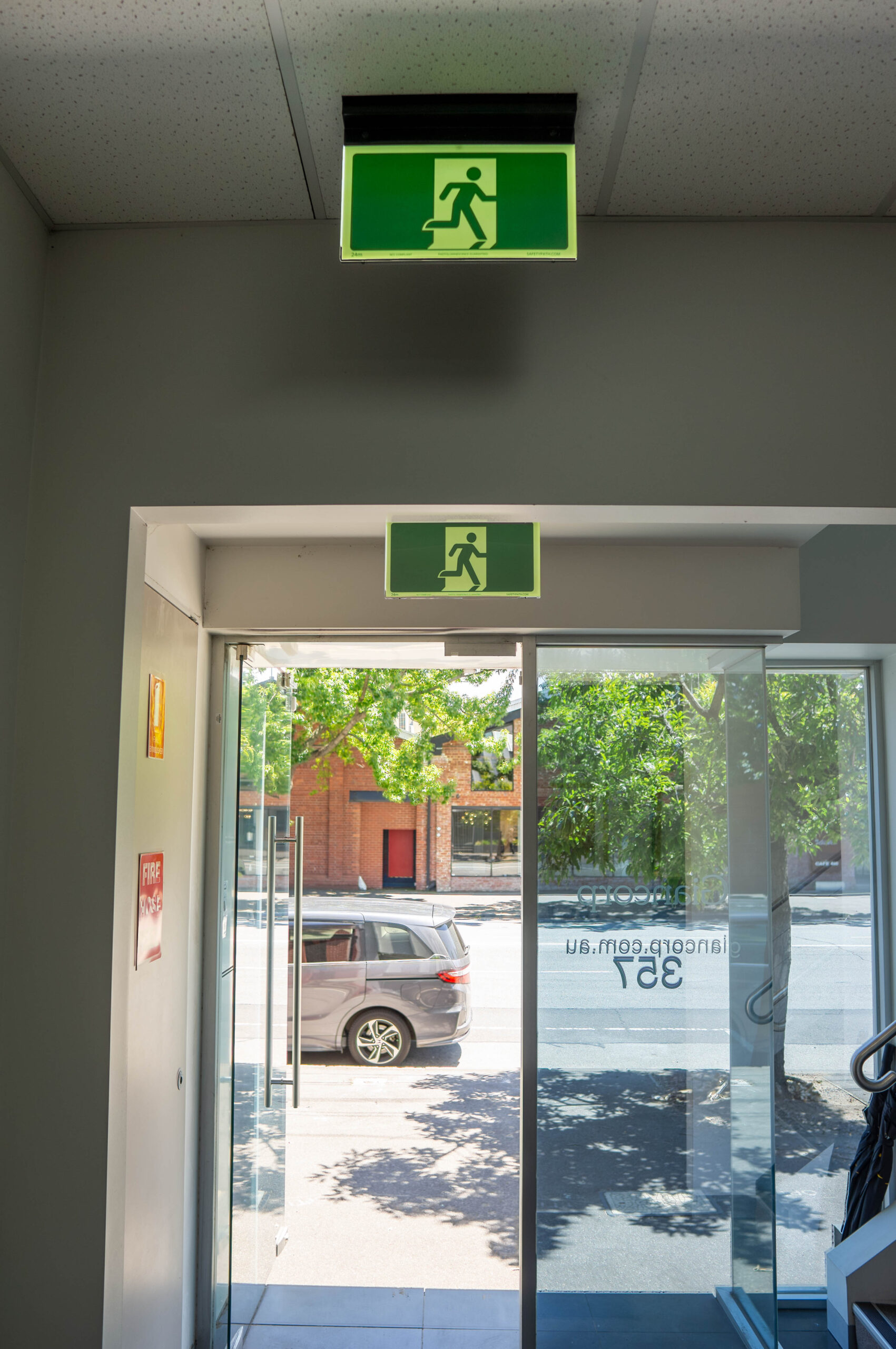 Two Safety Path Hybrid LED Exit Signs in Giancorp Building Foyer